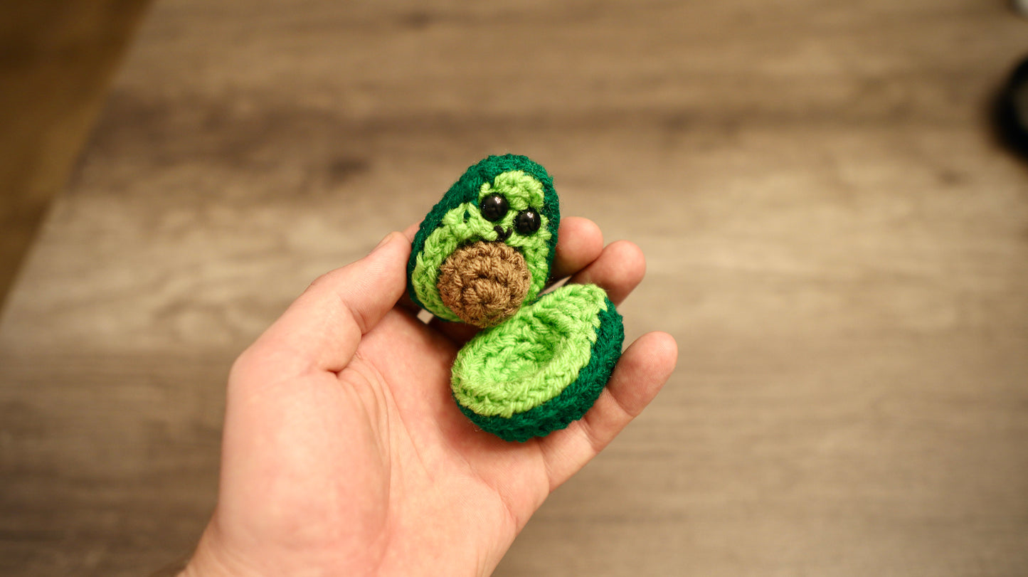 Green Avocado Held In Hand
